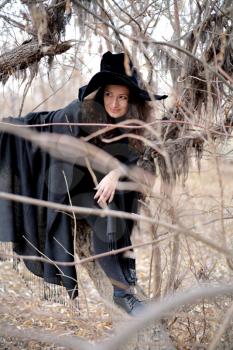 Shot of a gothic woman in a autumn park. Halloween.