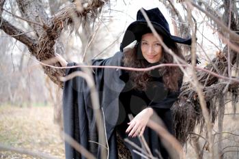 Shot of a gothic woman in a autumn park. Halloween.