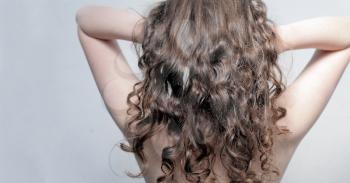 Beautiful female curly red hairs - back view