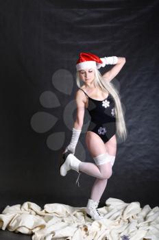 A Mrs. Santa dressed girl  studio shooting on gray background