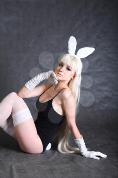 A bunny dressed girl  studio shooting on gray background