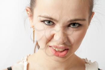 Angry american teenager face and shoulders over white background. Anger concept.