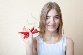beautiful girl with red pepper - organic food and health concept