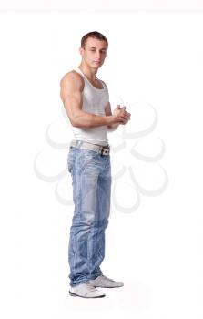 Sexy fashion portrait of a hot male model in stylish jeans with muscular body posing in studio on white