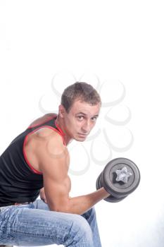 attractive athletic male torso with dumbbell sitting