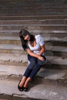 beautiful young woman outdoors on old stairs