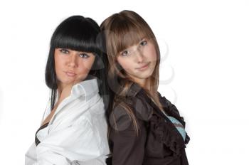 Two smiling attractive girl friends - blond and brunette on white background