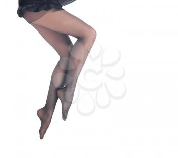 Beautiful female legs in black pantyhose on white