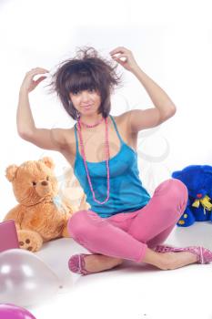 Pretty young woman in pink with teddy studio shot on white