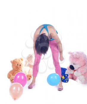 Young woman with toys in studio on white.