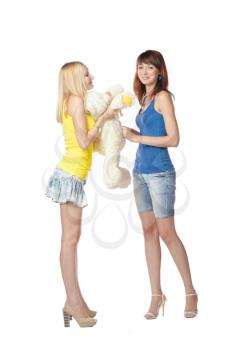 Two girlswith teddy bear isolated on white