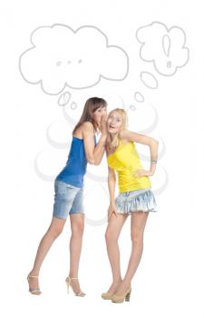 Two attractive girl friends thinking - blond and brunette on white background. Yellow and blue tank top and jeans.