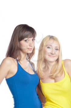 Two attractive girl friends - blond and brunette on white background. Yellow and blue tank top torso
