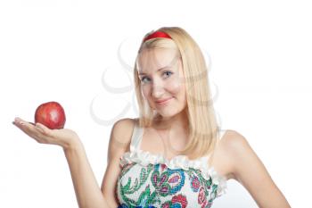 Beautiful blond holding an apple in hands health eating concept weared russian dress