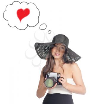 Young caucasian woman looking like Lady vintage weared with old film camera with very big lens isolated over white background. Baloon with heart shape sign. Love concept