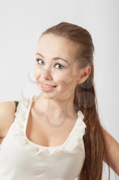 Young woman 20-24 years old looking at camera on white. Fun and joy with toothy smile white background
