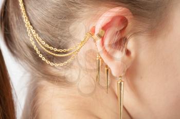 Woman ear with earring white background