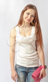 Portrait of a pretty, smiling blonde in jeans on white. 20-24 years old young women in studio front view