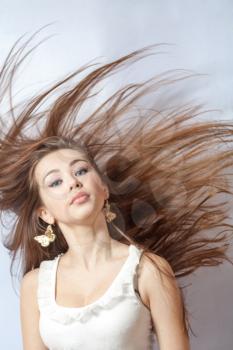portrait of a beautiful blonde girl with hair fluttering in the wind