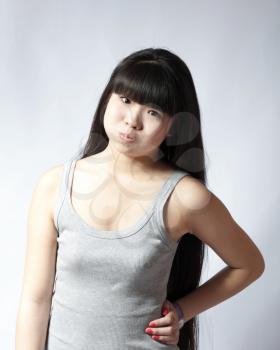 portrait of a lovely young asian woman studio on white headshot making face
