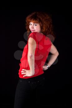 beautiful red hair woman in red dress on black