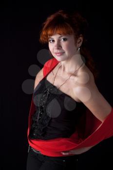 Portrait of beautiful redhead girl on black background