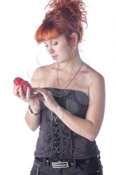 Portrait of beautiful redhead caucasian girl with heart in hand.