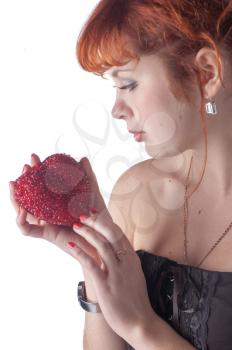 Portrait of beautiful redhead caucasian girl with heart in hand.