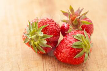 fresh berry: ripe raw strawberry over wooden plate