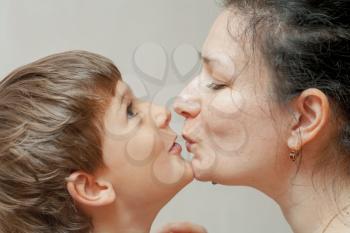Happiness of mother and little son. Kissing