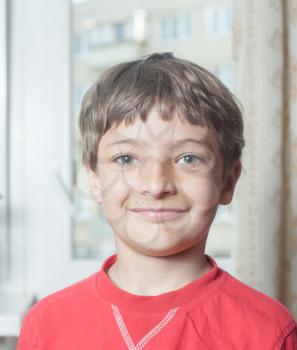 Portrait of an adorable young boy indoors in red shirt