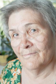 Blank expression closeup face senior woman. Indoors