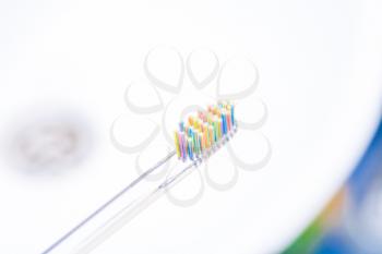 Colorful Toothbrush with Water Drops on White sink