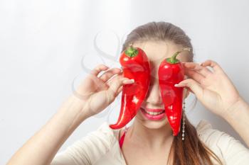beautiful girl with red pepper - organic food and health concept