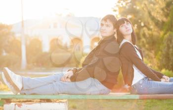 Happy couple against the background of autumn park, backlit composition, togetherness concept, love and tenderness