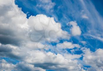 Fluffy white clouds in a blue sky background
