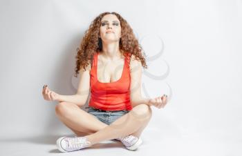 young woman do yoga meditation on white background her eyes closed