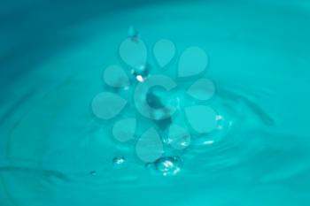 Photo of water splash on blue background