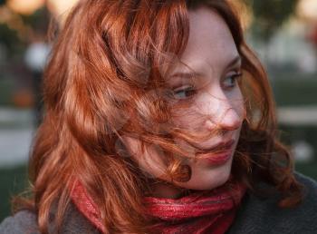 Close-up Portrait of the young 20s redhead women in autumn park. Headshot