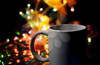 cup of hot coffee and christmas garland