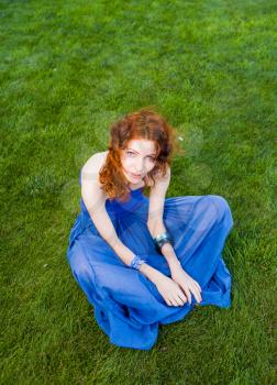 redhead  women meditating on grass