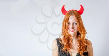front view shot of the redhead girl with red  horns looks like pretty Devil