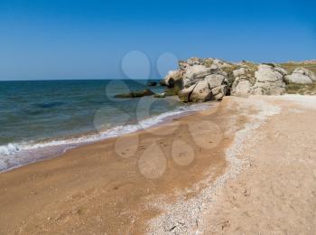 seashore with rocks and long sandy beach