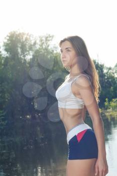 Sporty female outdoor torso image in profile
