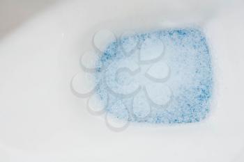 clear toilet bowl closeup with blue water