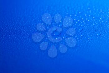 drops of liquid (water) on blue background
