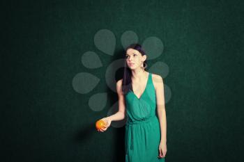 female with an orange in her hands with a lot of copyspace