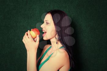 women playing with apple near face