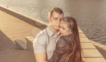 Couple near water embrace colorized image