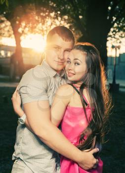 Couple embrace at sunset outdoors